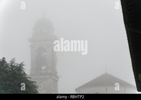 Cathedral Church bell tower in fog, gothic style. Stock Photo