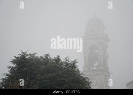 Cathedral Church bell tower in fog, gothic style. Stock Photo