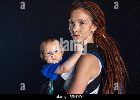 Biometric verification. Modern young woman with a child. The concept of a new technology of face recognition on polygonal grid is constructed by the p Stock Photo
