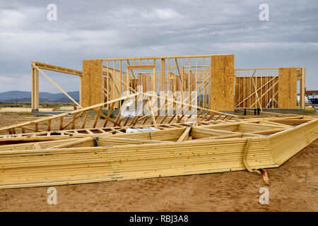 Residential house construction with factory built roof trussing ready to install on timber stud walls Stock Photo