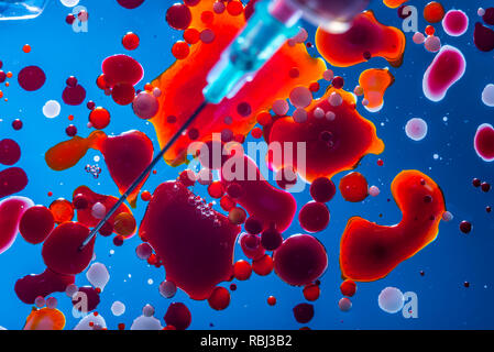Red bubbles of blood cells on a blue background closeup. Abstraction of medicine and science. The concept of micro processes and diseases in the human Stock Photo
