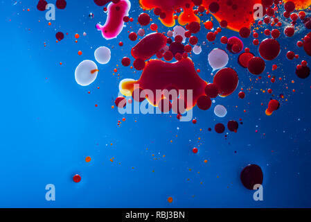 Red bubbles of blood cells on a blue background closeup. Abstraction of medicine and science. The concept of micro processes and diseases in the human Stock Photo