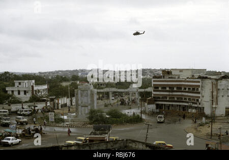 10th October 1993 A U.S. Army Bell AH-1 Cobra attack helicopter patrols low above the K-4 roundabout in Mogadishu, Somalia. Stock Photo