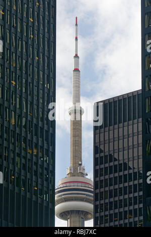 The CN Tower seen between two skyscrapers on Bay Steet in Toronto, Canada Stock Photo