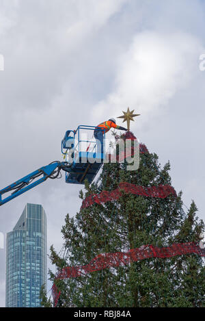 Workers putting the star on the Christmas tree in Nathan Phillips Square, Toronto, Canada Stock Photo