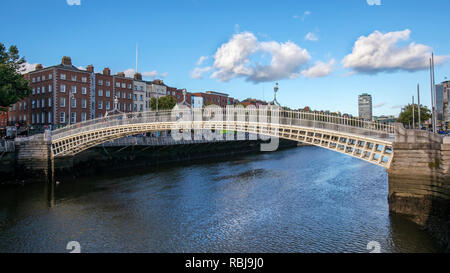 People walk over the Ha'penny Bridge over the Liffey River in Dublin, Ireland. Stock Photo