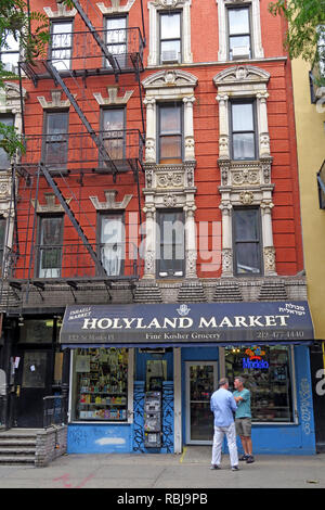 Two men outside Holyland Market, 122 St Marks Place, East Village, New York, NYC, NY, USA Stock Photo