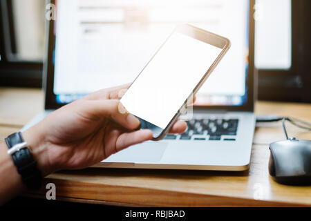 Close up of man using mobile smart phone,sending massages on the garden.having sunbath.Phone with black screen,texting,video calls, Stock Photo