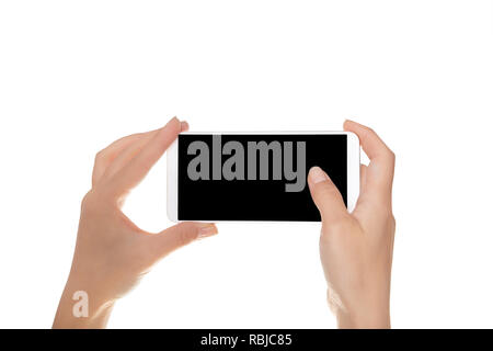 Mock-up of modern smartphone in the hands of a girl. Phone in horizontal position with a blank screen and isolated on white Stock Photo