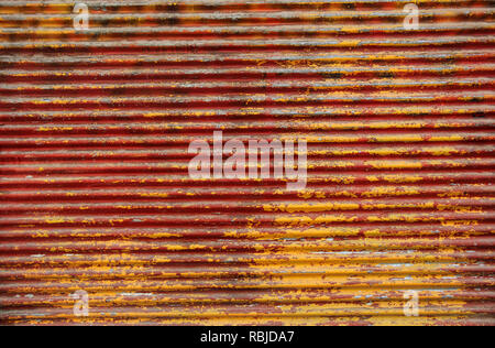 background image of rusty corrugated metal iron sheets red and yellow colors Stock Photo