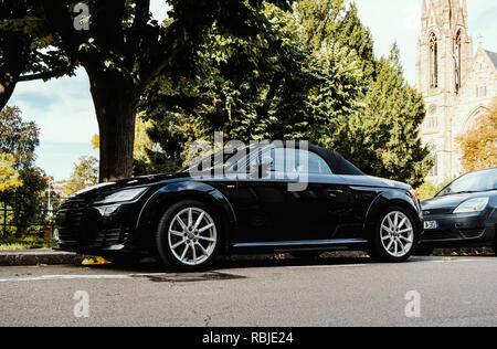 STRASBOURG, FRANCE - OCT 1, 2017: Modern luxurious Audi TT sport car parked in city with church building in the background Stock Photo