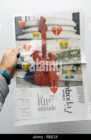 PARIS, FRANCE - DEC 18, 2017: Man holding Le Monde French newspaper showing news about Johnny Hallyday death Stock Photo