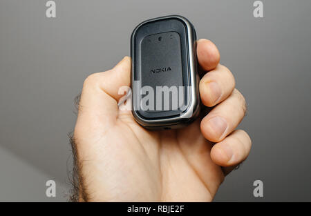 PARIS, FRANCE - DEC 18, 2017: Man holding vintage Nokia GPS bluetooth module used for pairing with old Nokia smartphones mobile phones  Stock Photo