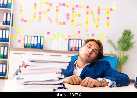 Young employee suffering from excessive work Stock Photo