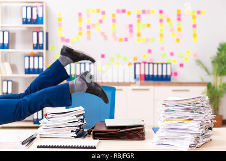 Young employee suffering from excessive work Stock Photo