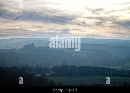 View of the North Downs near Dorking with the Leith Hill Tower on the Horizon on a misty winters day, Surrey England UK Stock Photo