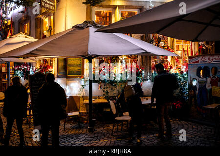STRASBOURG, FRANCE - NOV 21, 2017: People walking near the street terraces at night in Strasbourg  Stock Photo