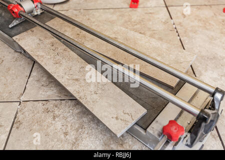 Using A Tile Cutter On Floor Stock Photo