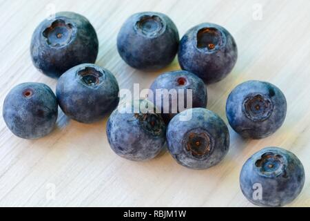 Close-up photo of fresh ripe blueberries on white wooden background Stock Photo