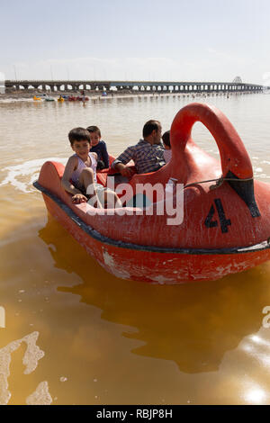 A man is riding a pedal boat with his children on the Urmia Lake, West Azerbaijan province, Iran Stock Photo