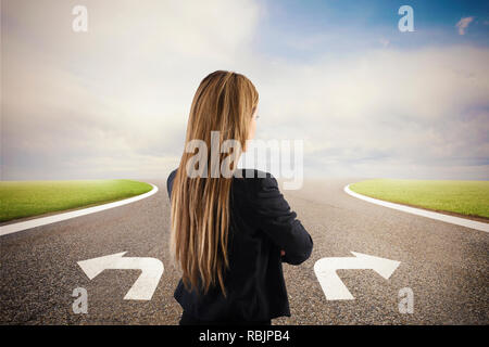 Businesswoman at a crossroads. She chooses the correct way. Concept of decision in business Stock Photo