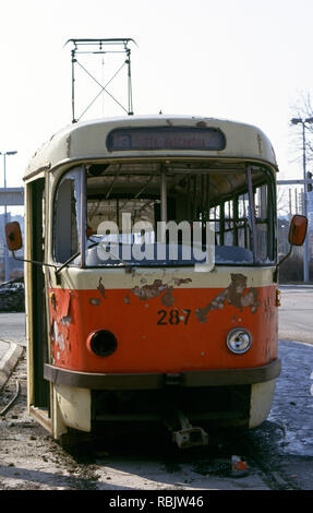 15th March 1993 During the Siege of Sarajevo: a wrecked tram on Sniper Alley, close to the Holiday Inn Hotel. Stock Photo