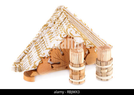 Paper napkins in wooden holder and toothpicks isolated on white background. Stock Photo