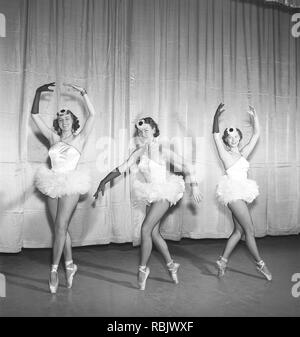 Ballerinas in the 1950s. Three young ballerinas all dressed up in their costume and shoes posing on a theatre stage in different positions. Photo Kristoffersson Ref BH41-12. Sweden 1953 Stock Photo