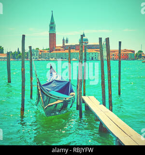 Venetian view with moored gondola, Venice, Italy. Retro style toned image Stock Photo