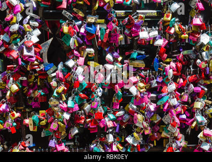 Detail of the entrance door to the Giulietta house in Verona. Full of colorful padlocks left by lovers on the promise of respect for mutual love. Conc Stock Photo