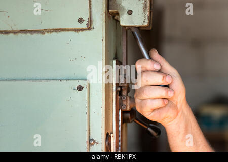 A male worker operating an industrial toggle switch. Stock Photo