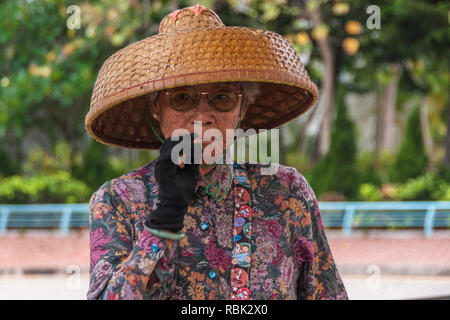 Wrinkles older woman with straw hat in 