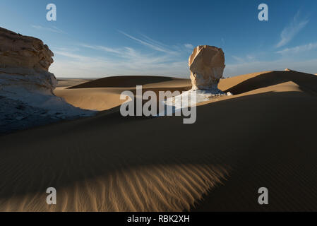 Amazing sunset landscape showing white chalk limestone rock formations in the Egyptian White Desert National Park Stock Photo