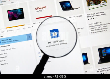 MONTREAL, CANADA - JANUARY 10, 2019: MIcrosoft Store app and logo under magnifying glass. Microsoft Store is a digital distribution platform owned and Stock Photo