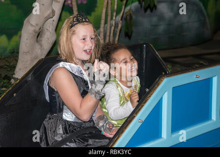 Bloomington, Minnesota. A young girl and her bi-racial sister on an amusement park ride at Nickelodeon Universe in the Mall of America. Stock Photo