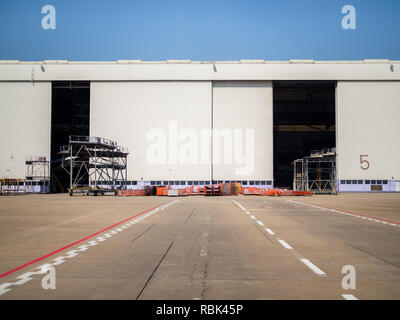 White warehouse number 5 in the airport. Warehouse gate near the runway in airport. Stock Photo