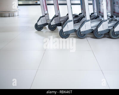 BANGKOK, THAILAND-November 5, 2018: Close-up wheels of airport luggage carts at the baggage claim in airport terminal with copy space.