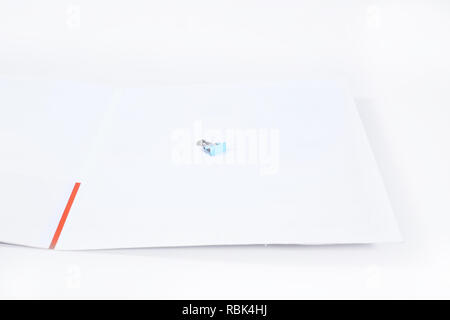 Portrait of paper clip on the magazine cover. Isolated on the white background. Stock Photo