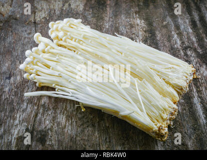 Golden Needle Mushroom - Enoki / Fresh golden needle mushroom from the farm on wooden background Stock Photo