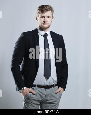 creative business man stands with his hands in his pockets.isolated on grey background Stock Photo
