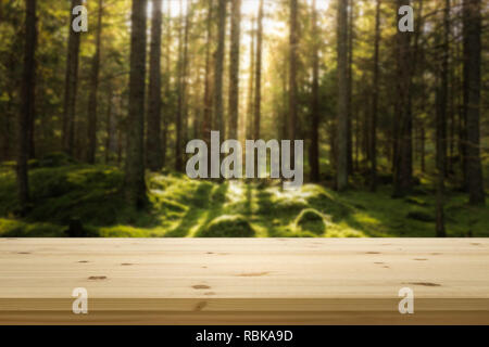 Wooden table top in front of green blured forest. Background for product display montage. Copy space design. Stock Photo