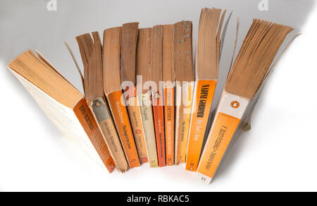 Collection of Penguin paper back books gathering dust from being left on a book shelf  for 20 years.  Berkshire, UK Stock Photo
