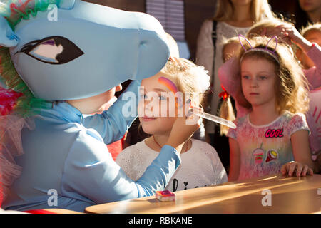 Belarus, Gomel, October 13, 2018. Holiday in the city. Children's party. The animator puts a face painting on the child. Stock Photo