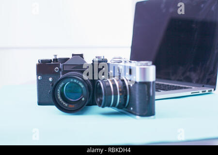 Computer keyboard, mouse and camera lie on table. Stock Photo