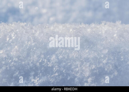 Background of fresh snow. Natural winter background. Snow texture in blue tone Stock Photo