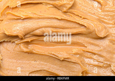 Smeared Peanut Butter Spread Background Texture Close Up. Stock Photo