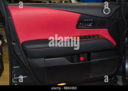 Interior of the SUV car with a rebuilt leather in red-black color in  exchange for the old worn-out interior trim in the workshop for repairing  the sea Stock Photo - Alamy