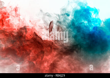 Multicolored pattern of the smoke of the green, blue and red colors of the mystical shape on a white isolated background. Abstract pattern in the form Stock Photo
