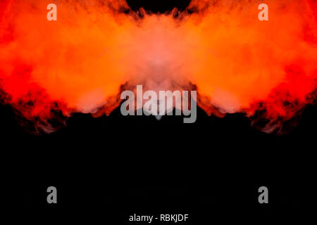 Flaming fire of smoke, rising upwards like a column, repeating the movement of red and orange air, curling and frosting into abstract shapes and patte Stock Photo