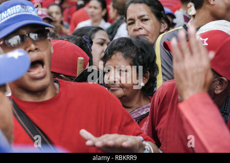 Caracas, Miranda, Venezuela. 10th Jan, 2019. An older woman is seen supporting Maduro in the middle of the crowd.Venezuelan President Nicolas Maduro started a second term, defying critics in the United States and Latin America who called him an illegitimate usurper of a nation where economic chaos has wrought a humanitarian crisis. The National Assembly calls the Maduro government a ''dictatorship and usurpation of power.'' Currently Venezuela is experiencing its worst economic crisis with an inflation rate of over 1,000,000% Credit: Roman Camacho/SOPA Images/ZUMA Wire/Alamy Live News Stock Photo